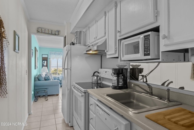 kitchen featuring white appliances, sink, light tile patterned flooring, white cabinetry, and ornamental molding