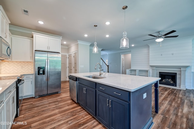 kitchen featuring stainless steel appliances, sink, and white cabinetry