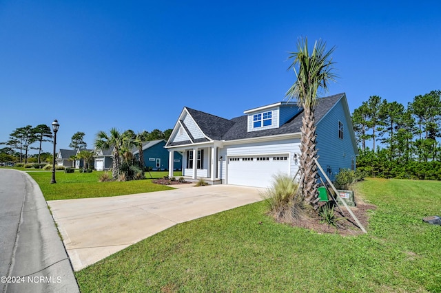 view of front of property with a front yard and a garage