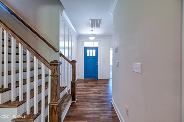 foyer featuring dark hardwood / wood-style floors and ornamental molding