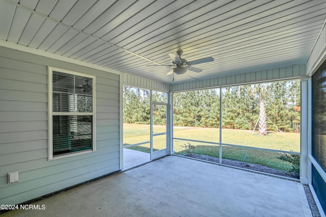 unfurnished sunroom with ceiling fan