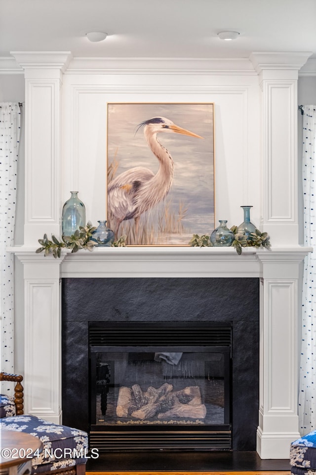 interior details featuring ornamental molding and hardwood / wood-style floors