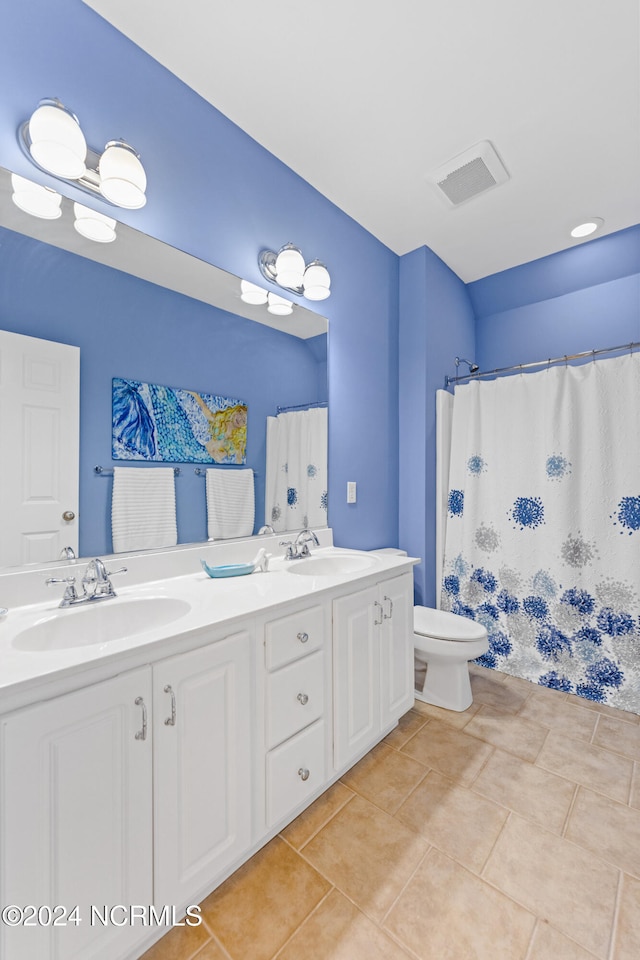 bathroom with tile patterned floors, vanity, toilet, and a shower with curtain