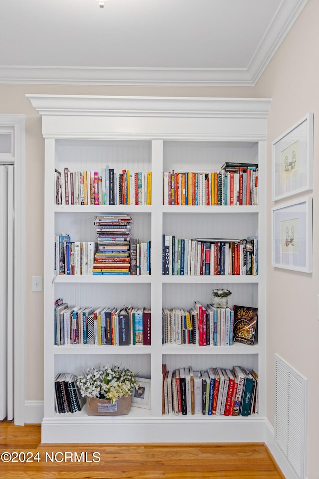 interior details featuring crown molding and hardwood / wood-style flooring