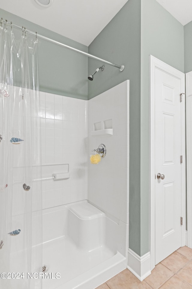 bathroom featuring tile patterned flooring and curtained shower