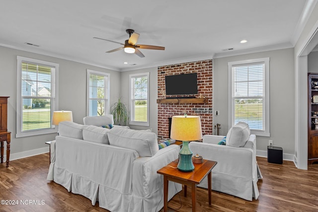 living room with dark hardwood / wood-style flooring, ceiling fan, ornamental molding, and a healthy amount of sunlight