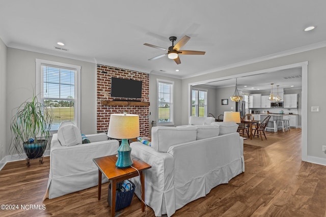 living room with hardwood / wood-style flooring, ceiling fan, and crown molding