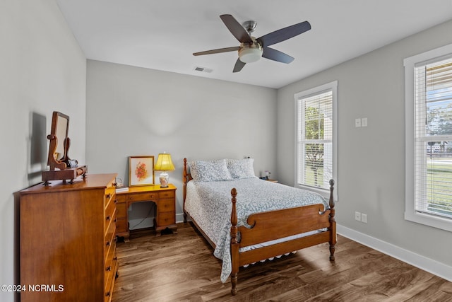 bedroom with ceiling fan and dark hardwood / wood-style floors