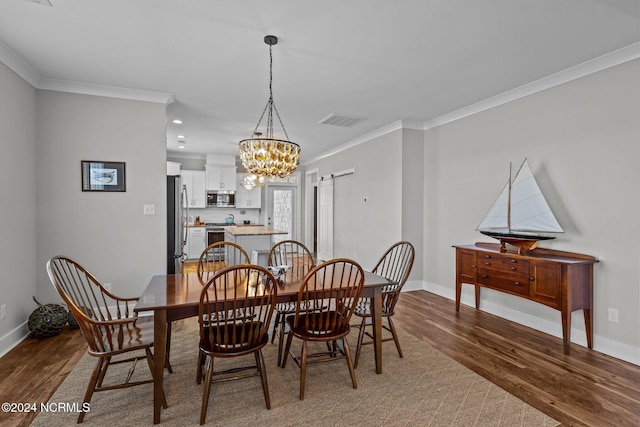 dining room with ornamental molding, a chandelier, and hardwood / wood-style flooring