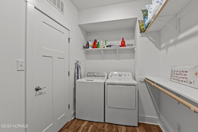 clothes washing area featuring dark hardwood / wood-style flooring and washing machine and clothes dryer