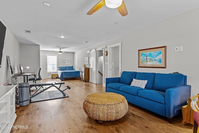 living room with hardwood / wood-style floors and a barn door