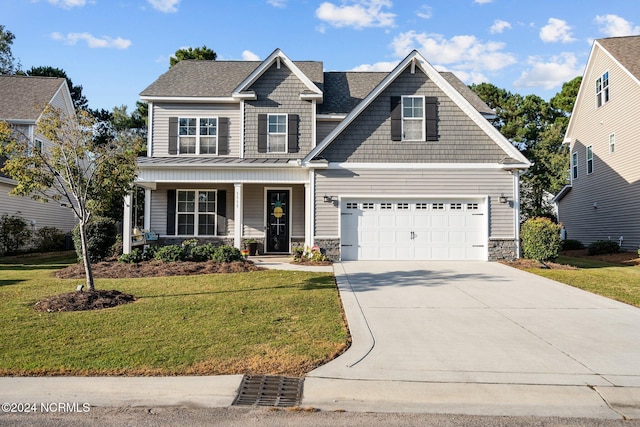 craftsman-style home featuring a porch, a front yard, and a garage