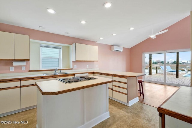 kitchen with an AC wall unit, a kitchen island, sink, kitchen peninsula, and a breakfast bar