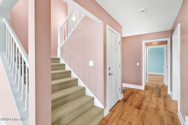 stairs with hardwood / wood-style floors