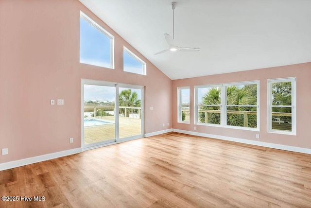 interior space featuring high vaulted ceiling, ceiling fan, and light wood-type flooring