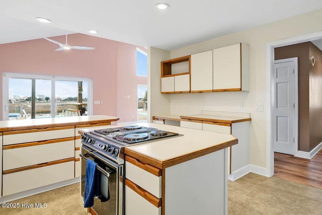 kitchen featuring ceiling fan, a center island, white cabinets, and electric stove