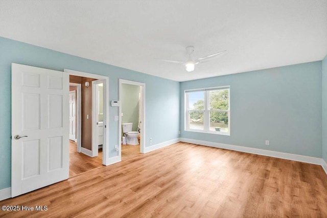 unfurnished bedroom featuring light wood-type flooring, ceiling fan, and ensuite bath