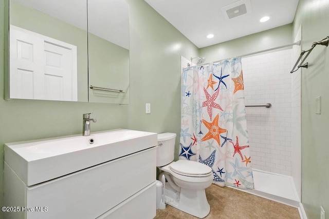 bathroom with walk in shower, vanity, and toilet