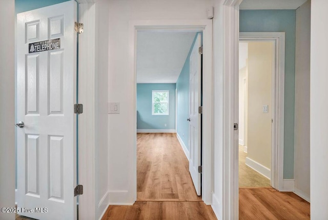 hall with light hardwood / wood-style floors