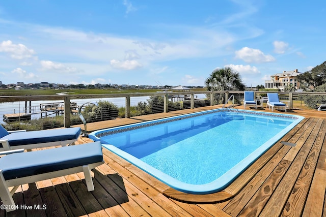 view of swimming pool with a water view