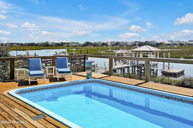 view of pool with a gazebo and a deck with water view