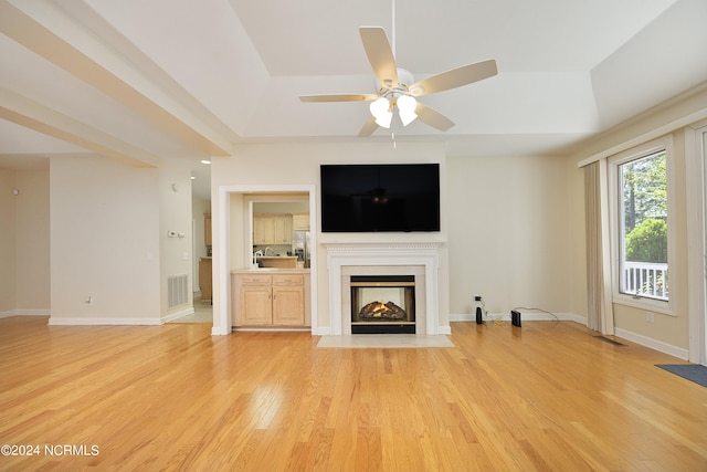 unfurnished living room with ceiling fan and light hardwood / wood-style floors