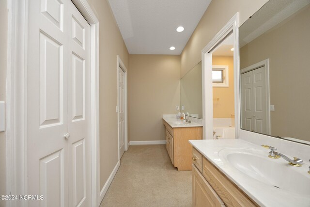 bathroom with a bathtub and vanity