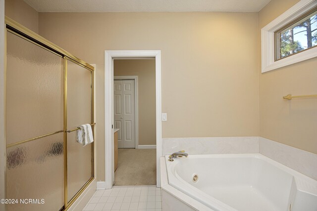 bathroom with plus walk in shower and a textured ceiling