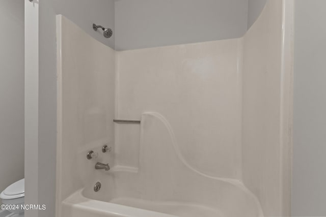 bathroom with toilet and tub / shower combination