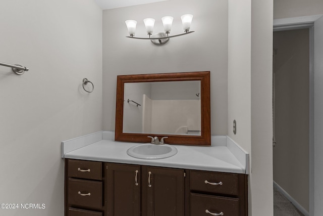 bathroom featuring vanity and a chandelier