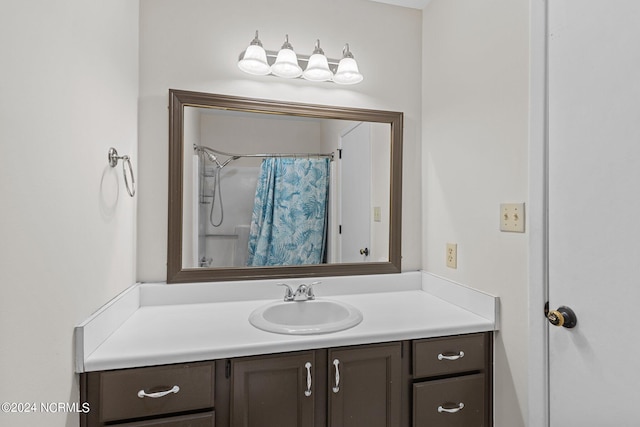 bathroom featuring vanity and curtained shower