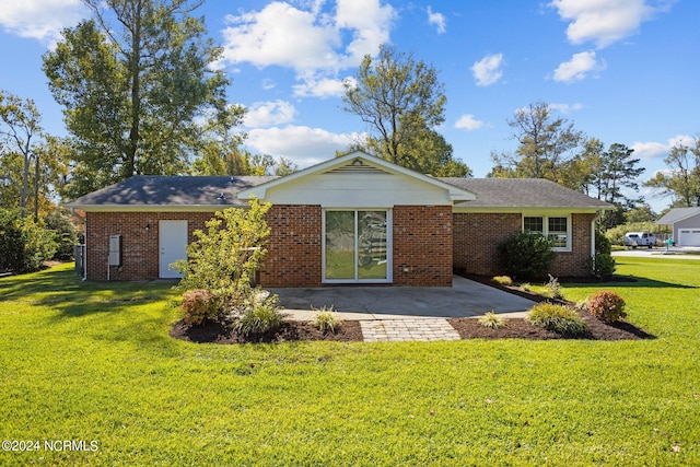 rear view of house with a yard