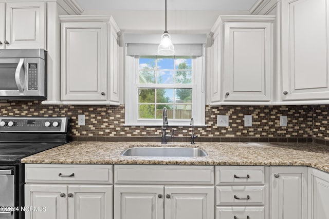 kitchen with white cabinetry, tasteful backsplash, appliances with stainless steel finishes, and sink