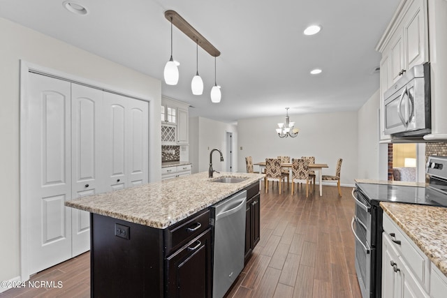 kitchen featuring appliances with stainless steel finishes, white cabinetry, and sink