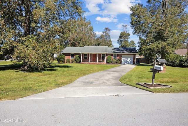 ranch-style house featuring a front lawn and a garage