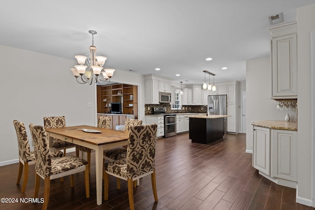 dining room featuring an inviting chandelier and dark hardwood / wood-style floors