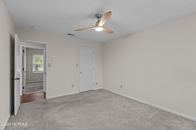 unfurnished bedroom featuring ceiling fan and light colored carpet