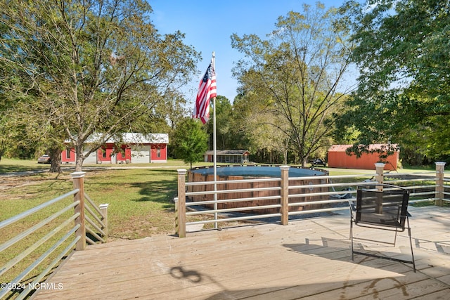 wooden terrace with an outbuilding and a lawn