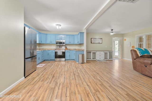 kitchen featuring stainless steel appliances, blue cabinets, light hardwood / wood-style flooring, and ceiling fan