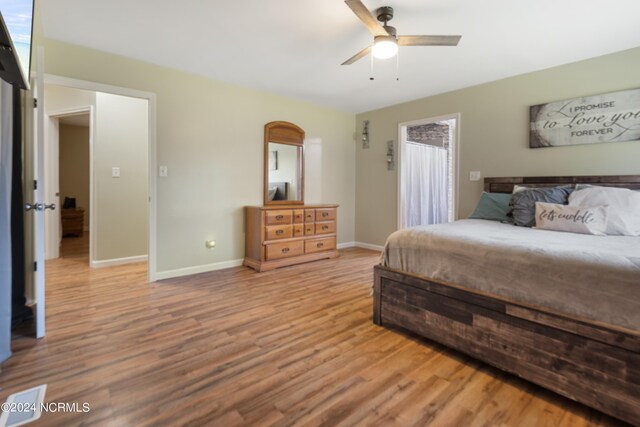 bathroom featuring a healthy amount of sunlight, hardwood / wood-style floors, vanity, and toilet