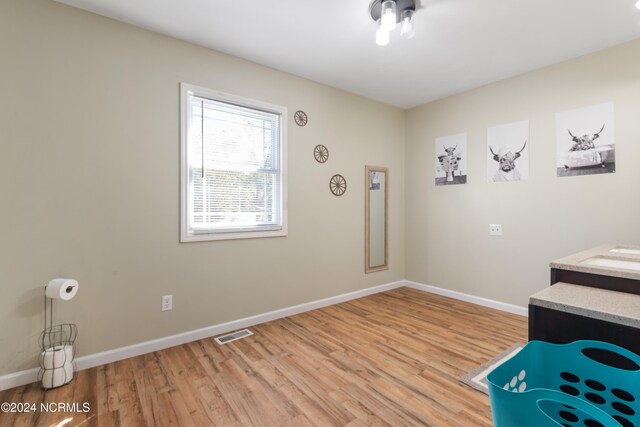 bedroom with light hardwood / wood-style floors and ceiling fan