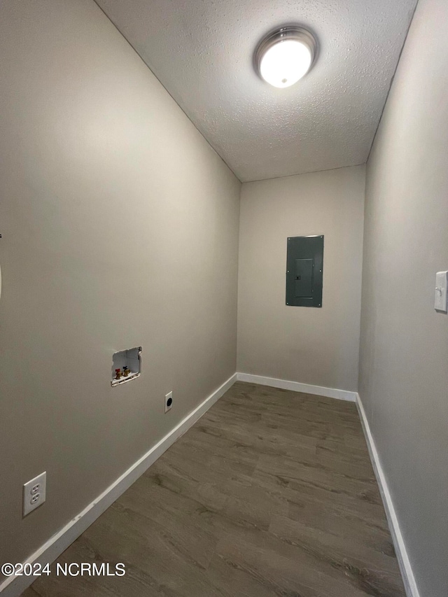 clothes washing area with dark hardwood / wood-style floors, hookup for an electric dryer, washer hookup, electric panel, and a textured ceiling