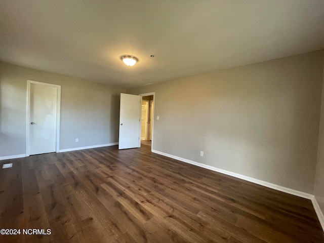 empty room with dark hardwood / wood-style floors