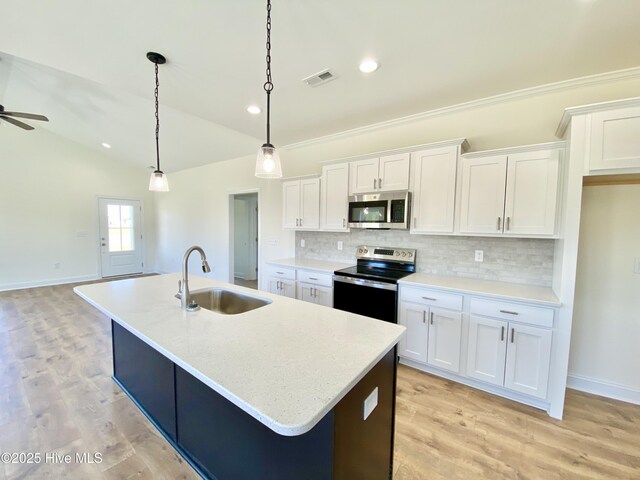 kitchen featuring white cabinetry, appliances with stainless steel finishes, an island with sink, and hanging light fixtures