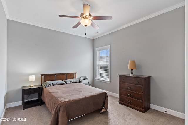 bedroom featuring ornamental molding, light colored carpet, and ceiling fan