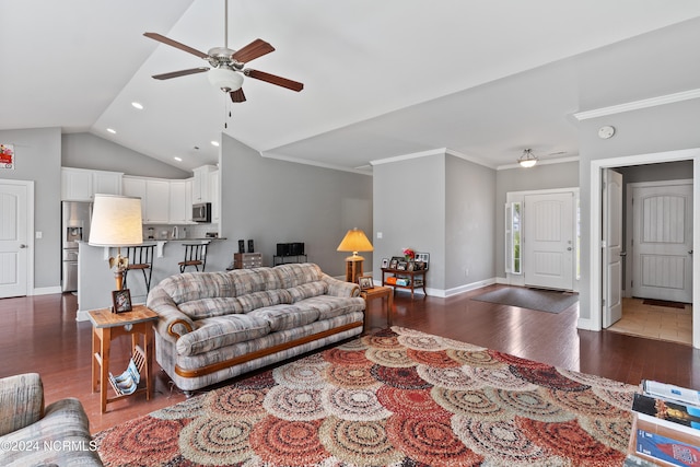 living room featuring dark wood-type flooring, ornamental molding, vaulted ceiling, and ceiling fan