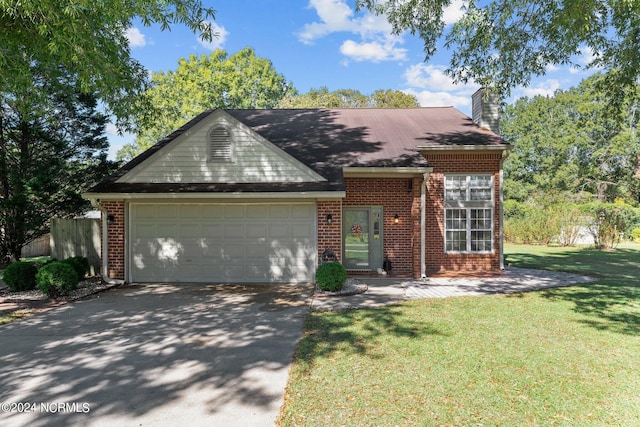 view of front of house featuring a front yard and a garage