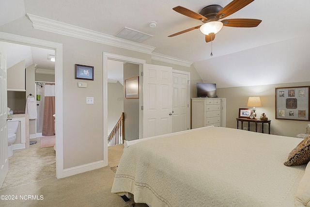 bedroom with ensuite bathroom, ceiling fan, light carpet, a closet, and vaulted ceiling