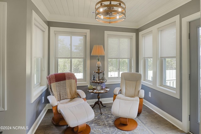 sitting room featuring plenty of natural light, ornamental molding, wood ceiling, and a chandelier