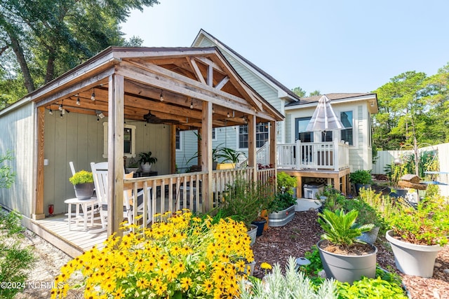 rear view of house with a deck and ceiling fan